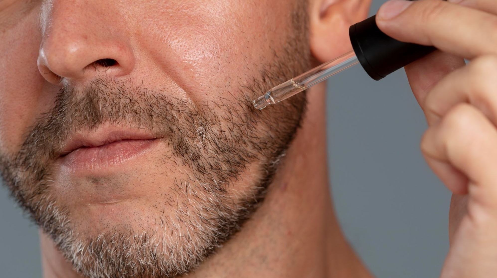 men applying minoxidil on beard