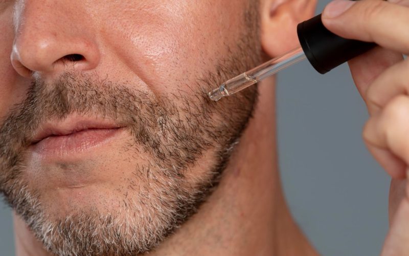 men applying minoxidil on beard